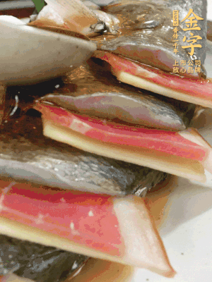 魚肚中塞蔥結(jié)、火腿片，魚身上碼放姜片、火腿片，倒入混合的料汁。