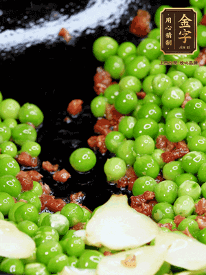 鍋內(nèi)少許油，下火腿煸香，再下甜豆米、百合翻炒，少許鹽、一點(diǎn)水煮到收干